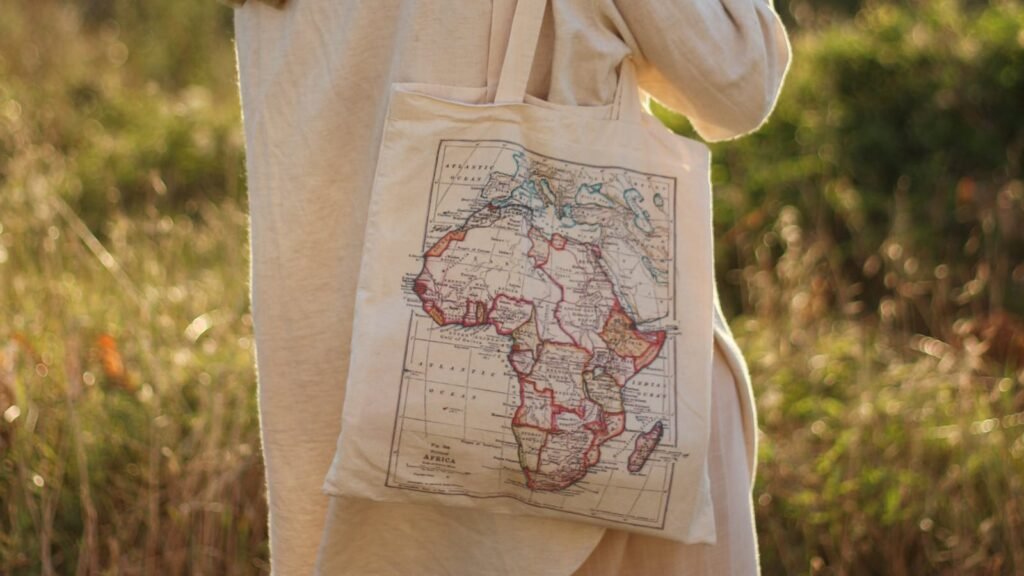 Close-up of a cotton tote bag with a printed map of Africa, promoting eco-friendly fashion.